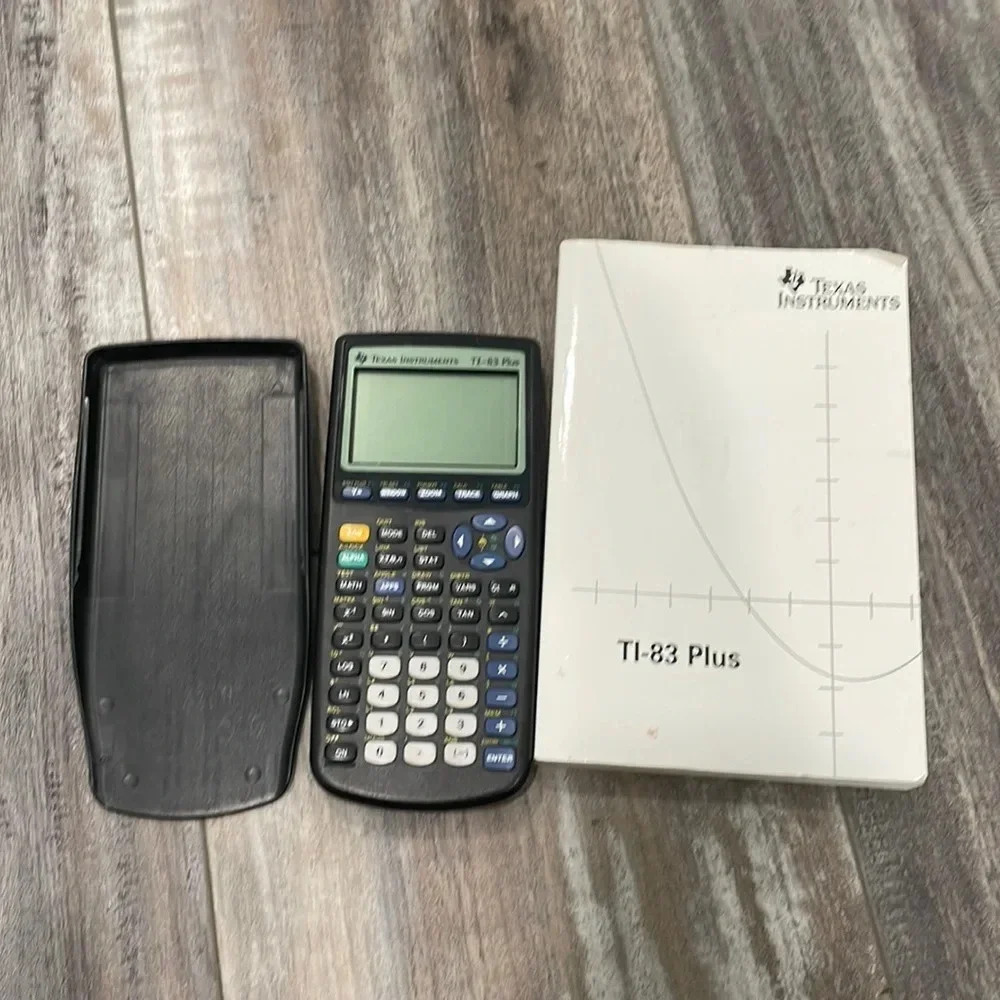 TI-83 Plus Calculator and instruction book